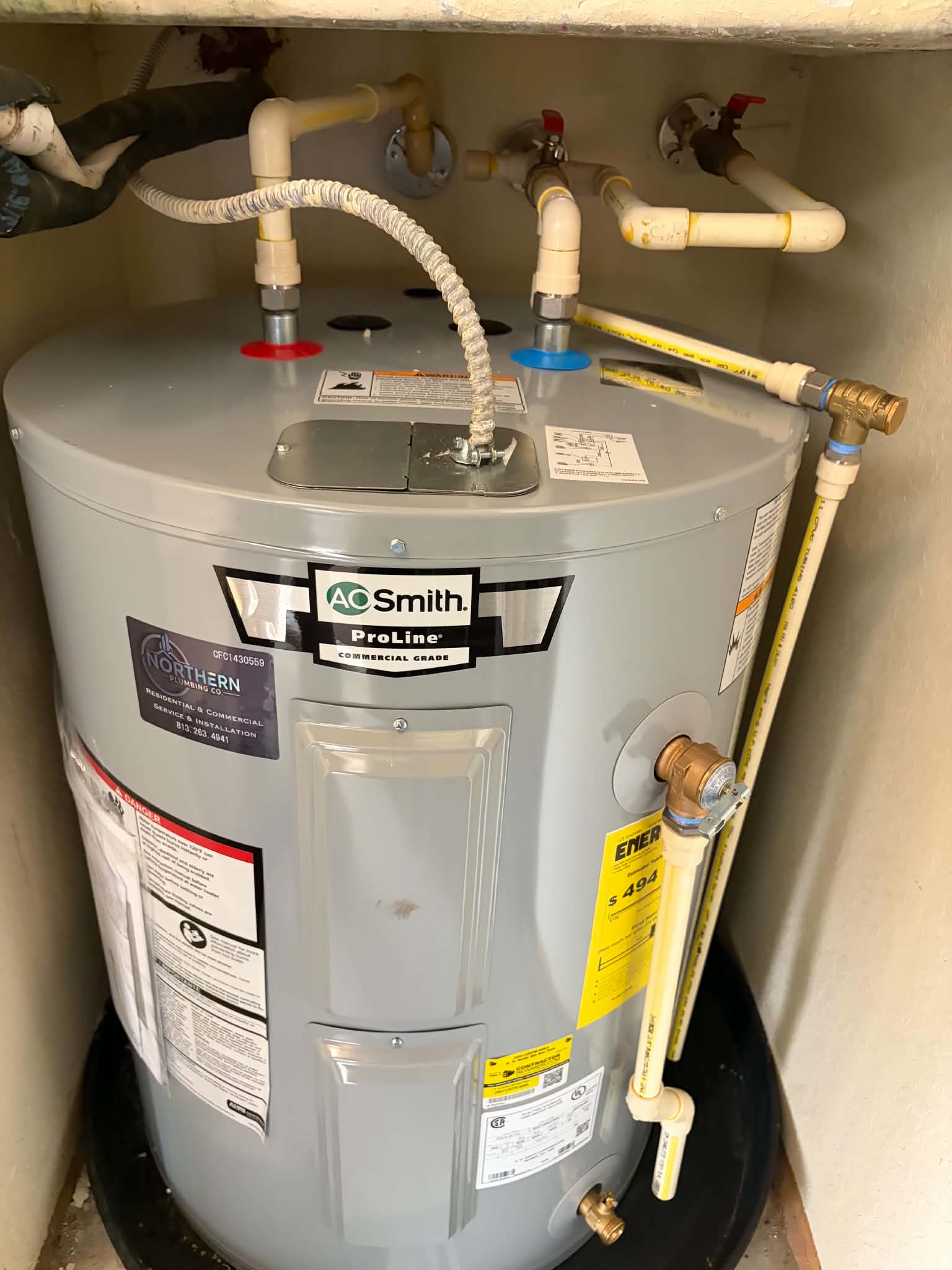 New A.O. Smith ProLine electric water heater with new T&P discharge line, installed by Northern Plumbing Co. in a St. Petersburg condo utility closet