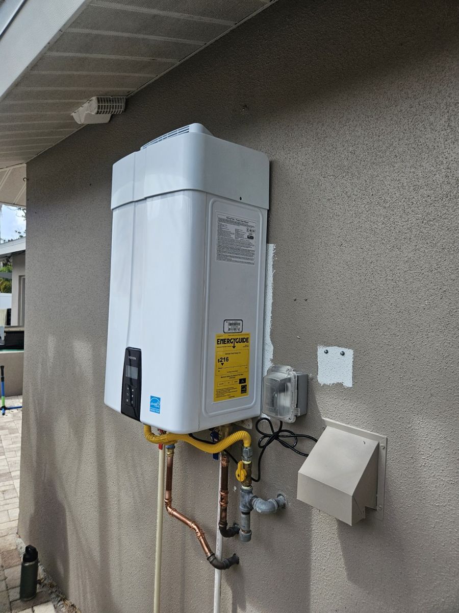 New Navien gas tankless water heater installed on the outside wall of a Tampa home